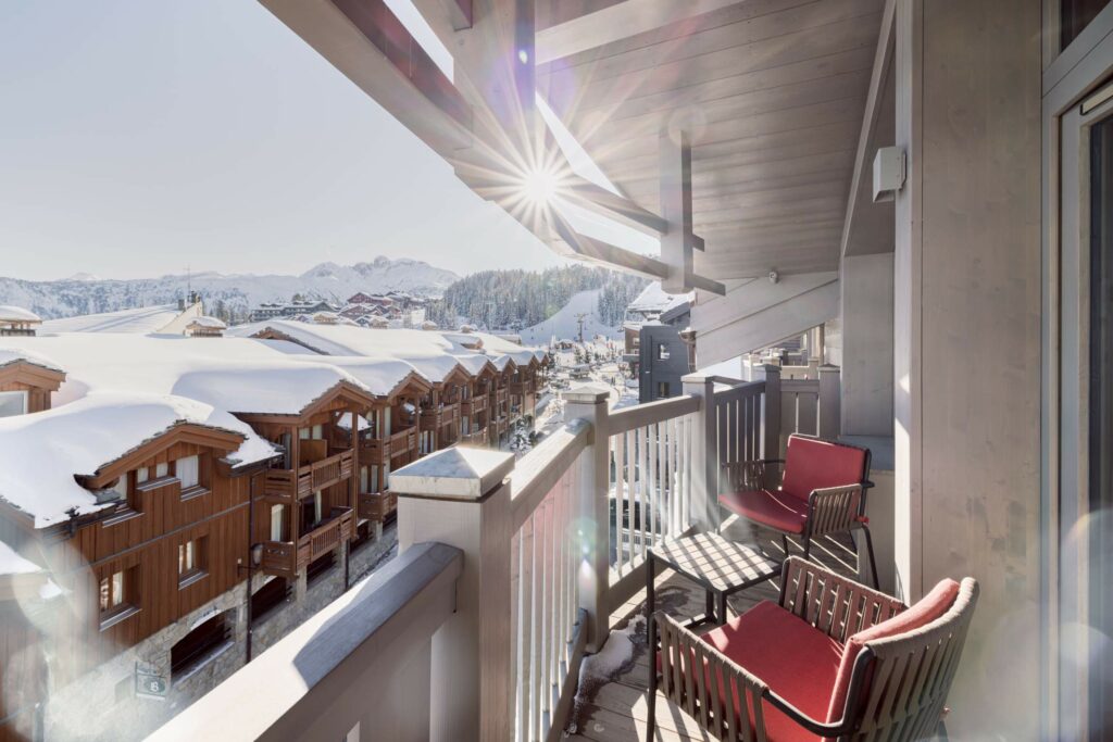 Vue depuis une terrasse K2 Collections Courchevel sur les chalets enneigés
